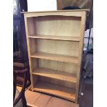 A modern light oak open bookcase fitted four shelves (150cm x 101cm x 33cm)