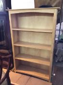 A modern light oak open bookcase fitted four shelves (150cm x 101cm x 33cm)