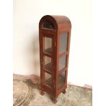 An unusual hardwood display cabinet, the domed top with half moon glass to front, above a single