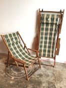 A pair of Australian sou-wester folding deckchairs, with tartan pattern sling seats (unfolded: