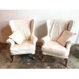 A pair of wing back Parker Knoll armchairs, both in foliate pattern loose cover in ivory, on