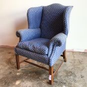 An early 20thc wing back armchair, possibly by Whytock & Reid, Edinburgh, with hump back and