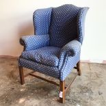 An early 20thc wing back armchair, possibly by Whytock & Reid, Edinburgh, with hump back and