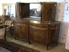 A mid 19thc sideboard the upper tier with gallery top, corner doors to sides and turned supports