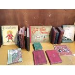 A collection of children's books including an 1872 publication of Alice in Wonderland, an 1877
