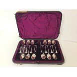 A Walker & Hall 1920s set of twelve coffee spoons with sugar nips, in original box (18cm x 26cm)