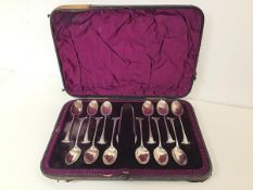 A Walker & Hall 1920s set of twelve coffee spoons with sugar nips, in original box (18cm x 26cm)