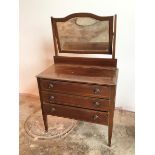 An Edwardian dressing table, the bevelled glass mirror with domed top, supports lacking finials,