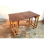 A teak expanding table, with a lift and fold mechanism and concertina style support (open: 54cm x