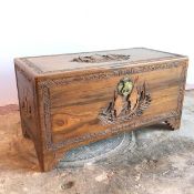 A Chinese hardwood trunk with maritime scene carved to top and sides within Chinese design border,