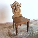 A late Victorian mahogany hall chair with shield back, on front turned supports (89cm x 45cm x