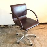 A Frag office swivel chair in dark purple upholstery, with quarter hooped arms, on swivel base, with