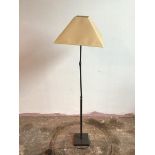 A metal standard lamp with ball hinge lamp holder and two adjustable hinges to stem, on square base,