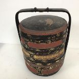 An early 20thc Japanese lacquer and gilt decorated circular food carrier with fixed handle above
