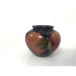 A small Moorcroft vase, of urn form with fruit decoration, stamped Moorcroft to base (6cm x 8cm)