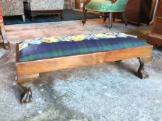 A 1920s/30s mahogany footstool with drop in upholstered cushion with tartan fabric and applied