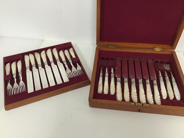 An Edwardian cutlery canteen with a set of twelve fruit knives and forks, with mother of pearl