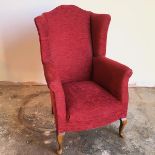A modern walnut wing back armchair in claret upholstery (103cm x 66cm x 70cm)