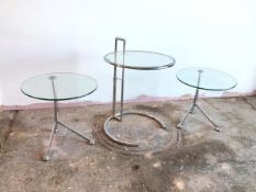 An Eileen Gray style side table with circular glass top on adjustable metal frame (full height: 76cm