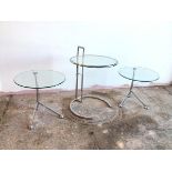 An Eileen Gray style side table with circular glass top on adjustable metal frame (full height: 76cm