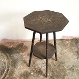 An early 20thc pokerwork octagonal plant stand, with central starburst design surrounded by