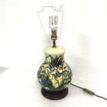 A Moorcroft table lamp of baluster form and decorated with water lilies and other flowers, on