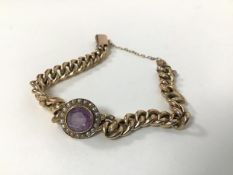 A 9ct gold curb link bracelet set to centre with a bar probably associated collet set amethyst