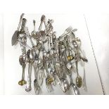 An assortment of Epns flatware including dinner forks, spoons, sugar nips, fish slices, souvenir