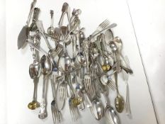 An assortment of Epns flatware including dinner forks, spoons, sugar nips, fish slices, souvenir