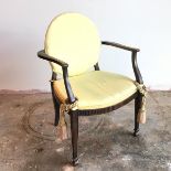 An early 19thc style open armchair, with upholstered circular back above a cushioned seat, on