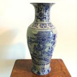 A Chinese baluster shaped vase, with flared rim and blue decorated body, having two panels depicting