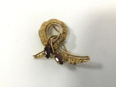 A 1970s yellow metal brooch set with two marquise garnets (4.5cm) (8.82g)