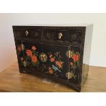 A neat modern ebonised Chinese cabinet, fitted two frieze drawers above a pair of cabinet doors,