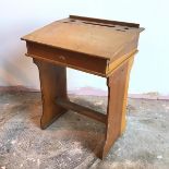 A 1920s/30s child's school desk, with hinged sloped top (70cm x 51cm x 41cm)