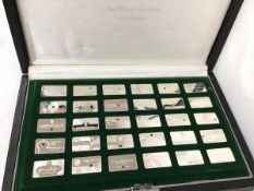 A boxed set of silver ingots, each inscribed with a different mining company and a speciman stone (