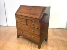 A George II Irish walnut bureau, c. 1750, the fall front enclosing a fitted interior with shaped