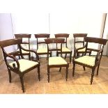 A set of seven George IV mahogany dining chairs, including a pair of elbow chairs with bugle-