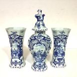 A garniture of three Delft blue and white vases, probably 18th century, comprising a covered vase of