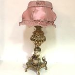 A brass and onyx paraffin lamp, converted for electricity, with bulbous well, baluster column and