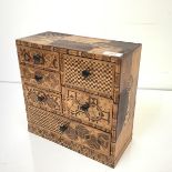 A 19th century Japanese table cabinet, asymmetrically veneered and parquetry inlaid with contrasting