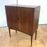 A Danish rosewood drinks cabinet, the pair of cupboards opening to a mirrored interior, shelves