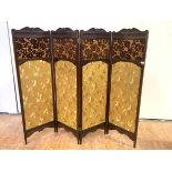 An Aesthetic Movement walnut-framed four-fold screen, c. 1890, each with shell and scroll crest,