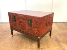 A Chinese red lacquered leather trunk, mid-20th century, the hinged top with later perspex cover,