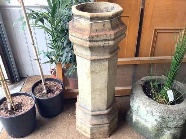 A 19th century buff terracotta chimney pot, of hexagonal form. 94cm by 32cm