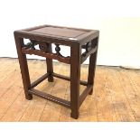 A Chinese hardwood occasional table, early 20th century, with recessed rectangular top and pierced