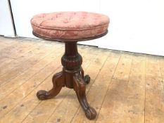 A mid-19th century rosewood adjustable piano stool, the button-upholstered seat on a reeded shaft