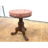 A mid-19th century rosewood adjustable piano stool, the button-upholstered seat on a reeded shaft