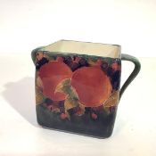 William Moorcroft, a Pomegranate pattern biscuit box (lacking cover), with shaded green ground, with