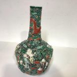 A Chinese porcelain reticulated vase, 19th century, of bottle form, decorated in relief with figures