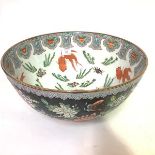 A large Chinese famille noir porcelain punch bowl, the interior painted with carp amidst fronds, the